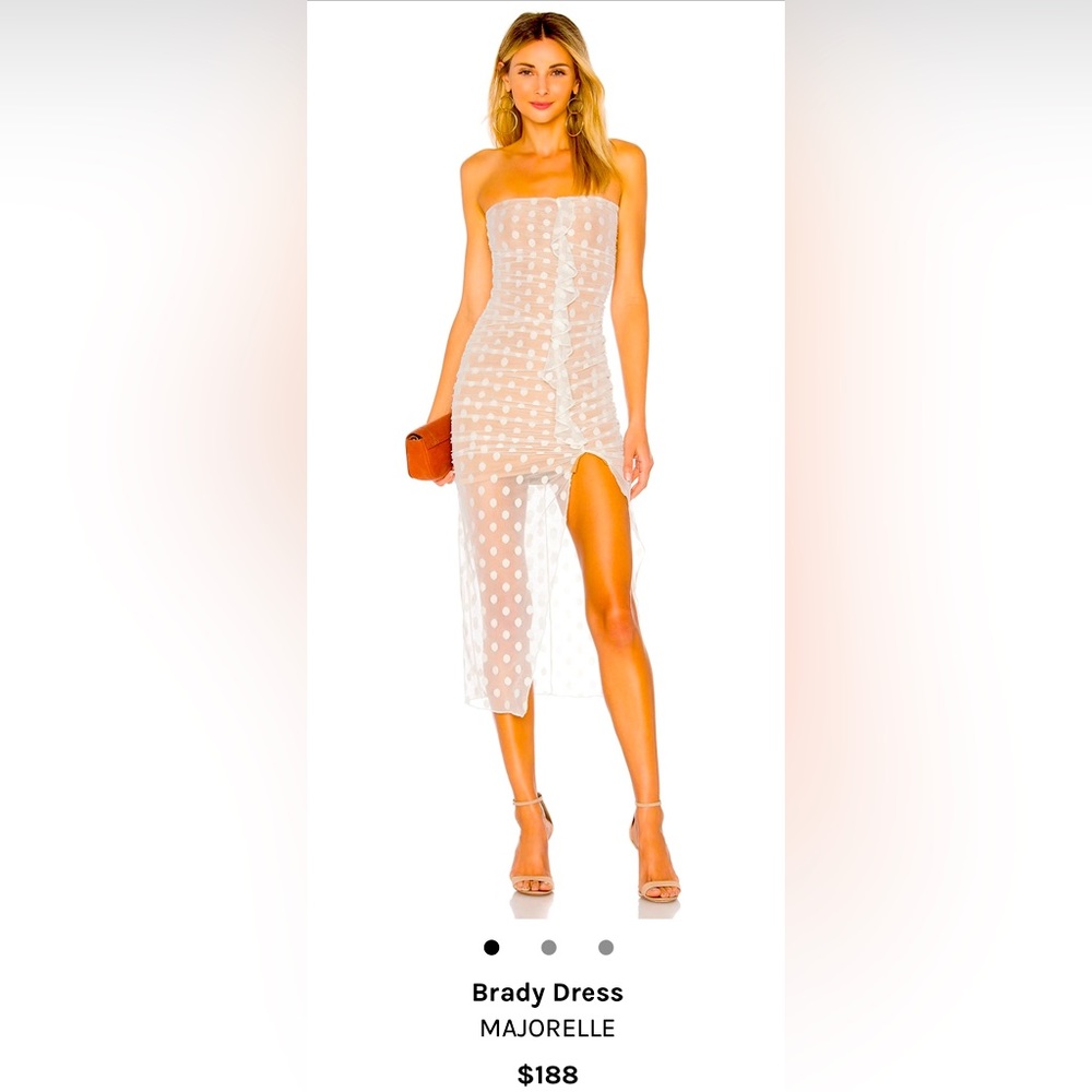 MAJORELLE white polkadot dress.
Ruched mesh fabric with ruffle trim. Stretch fit